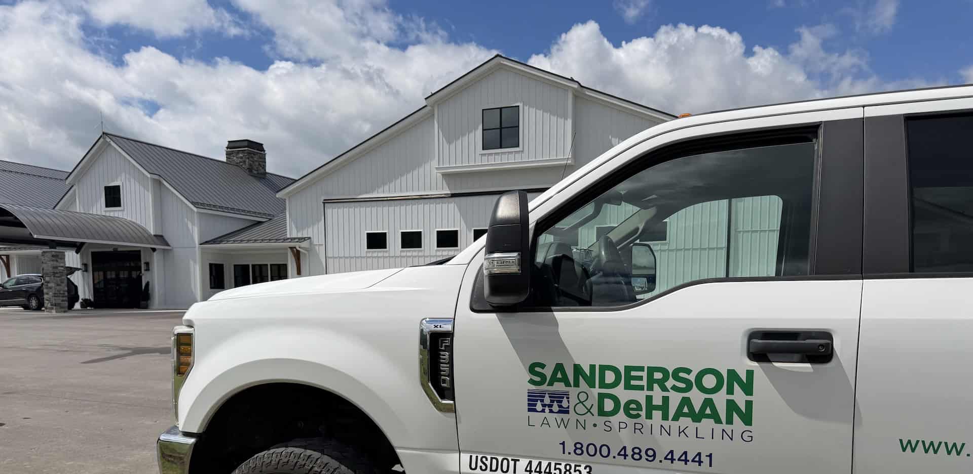 Sanderson & DeHaan irrigation truck arriving for a sprinkler system installation in Grand Rapids, Michigan.