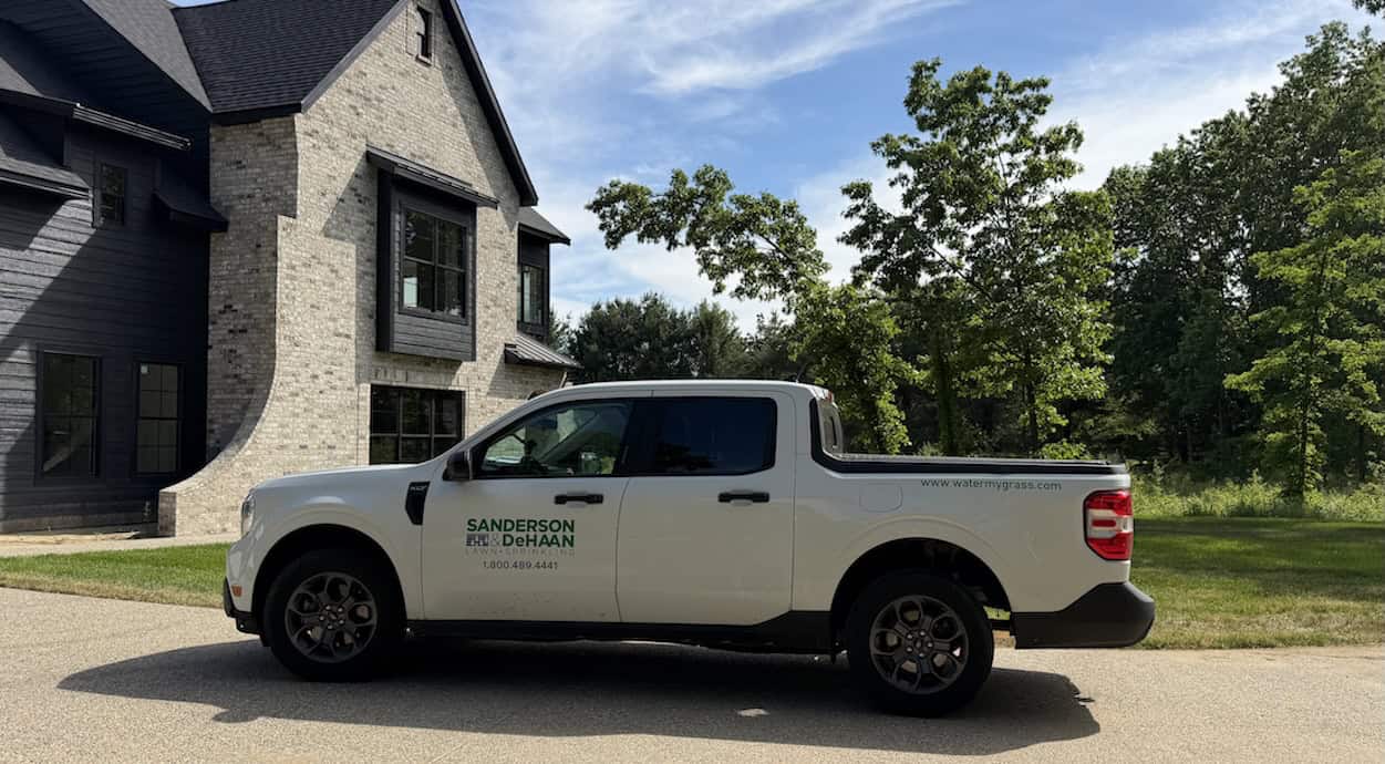 Sanderson & DeHaan irrigation truck arriving at a new sprinkler system installation project in Grand Rapids, Michigan.