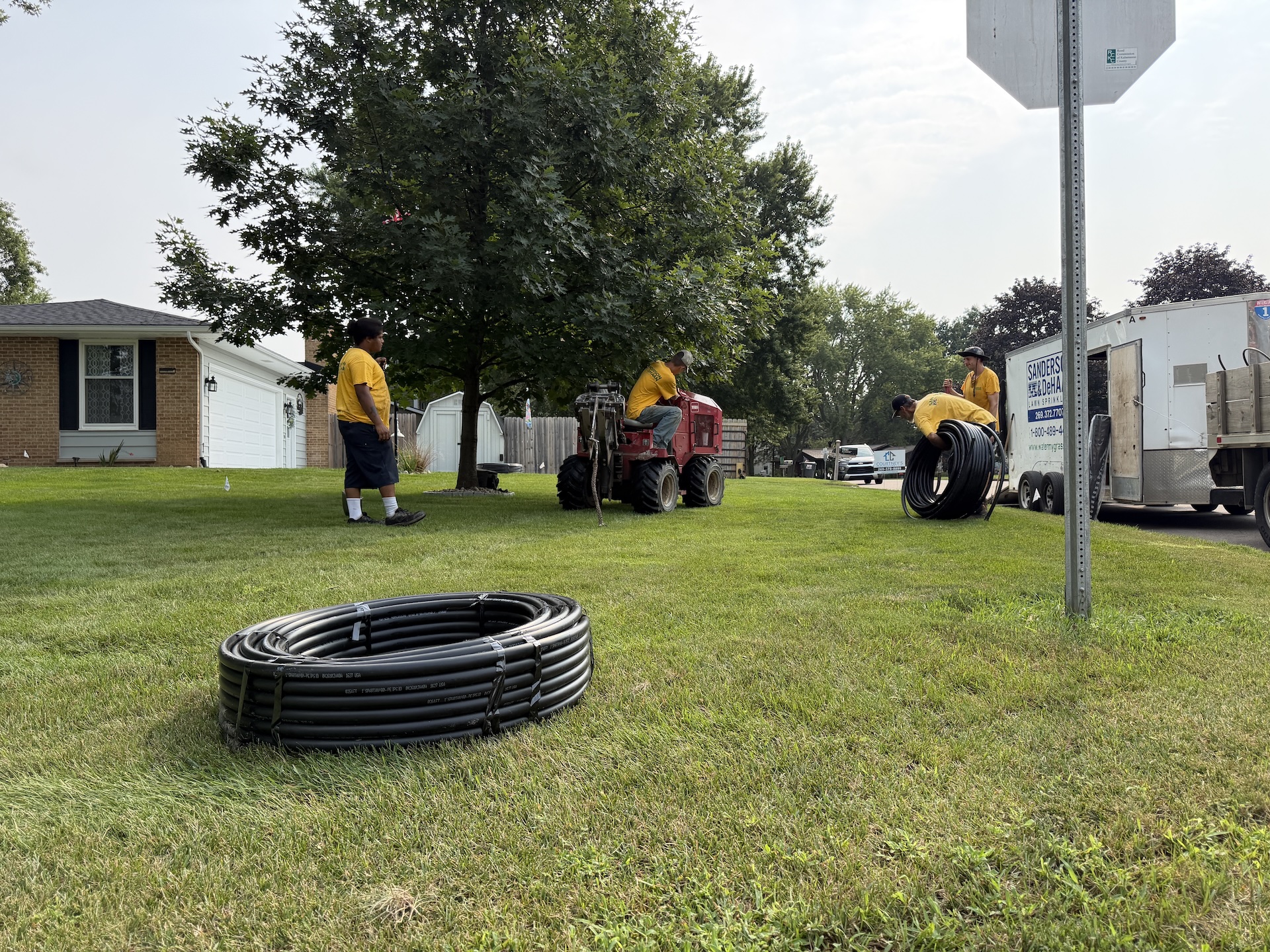 Sanderson & DeHaan crew and equipment working on a residential sprinkler installation in Schoolcraft